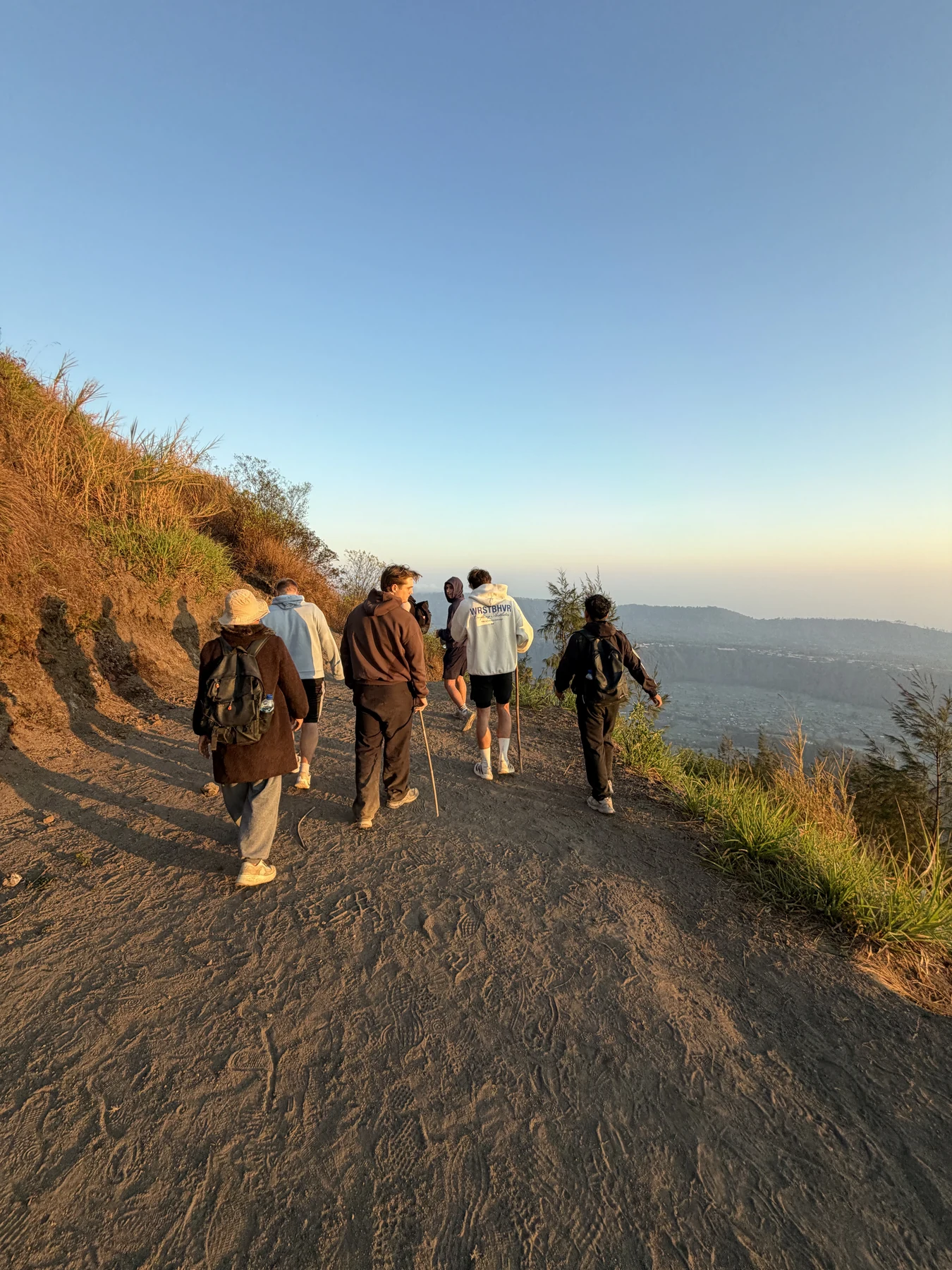 Die Gruppe wandert im warmen Morgenlicht auf einem Bergpfad auf Bali